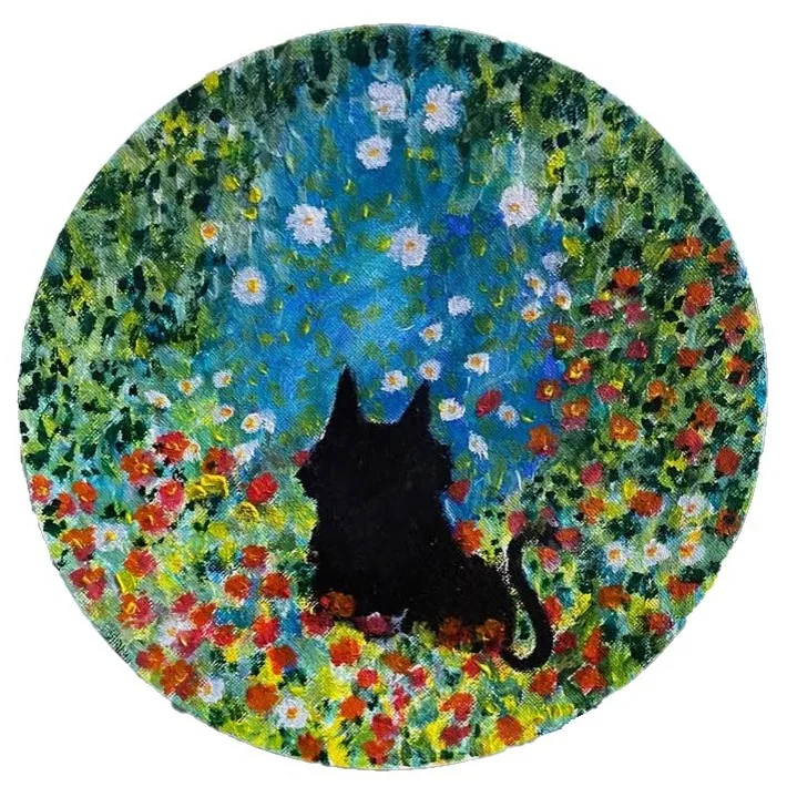 Round painting by Flavia of a black cat in a flower garden
